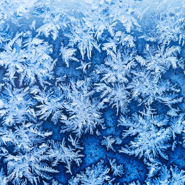 Snowflakes and frost on window glass close up — Stock Photo, Image