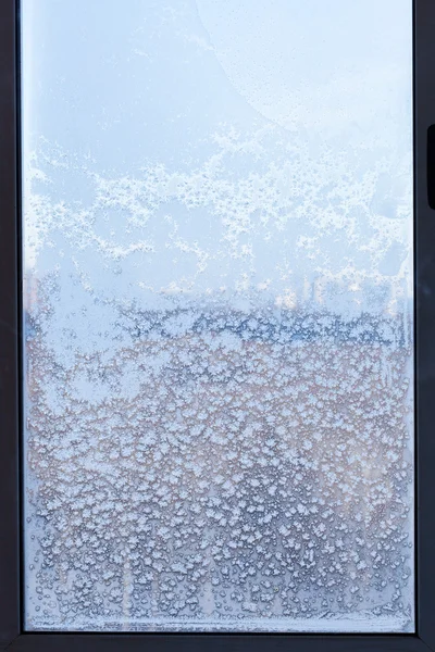 Cityscape through the snow-covered window — Stock Photo, Image