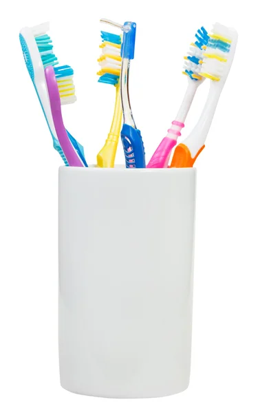 Cinco cepillos de dientes y cepillo interdental — Foto de Stock