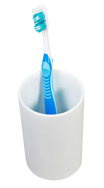 Jedna modrá zubní kartáček v keramické sklo — Stock fotografie
