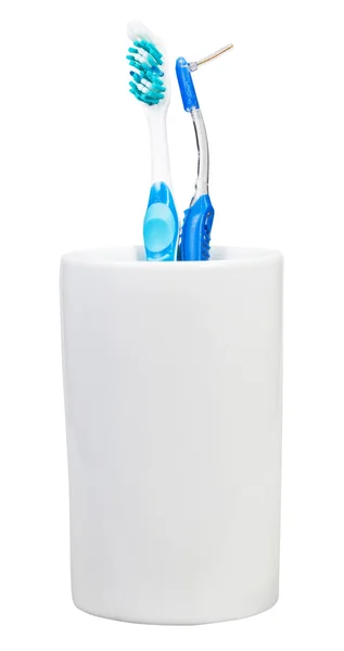 Toothbrush and interdental brush in ceramic glass — Stock Photo, Image