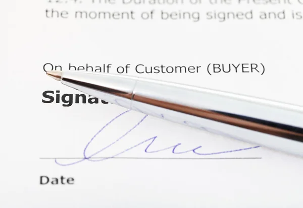signature of sales contract and silver pen