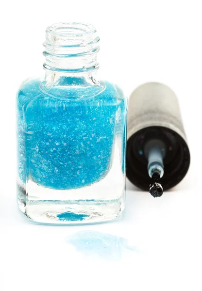 Bottle with spilled turquoise nail polish on white — Stock Photo, Image