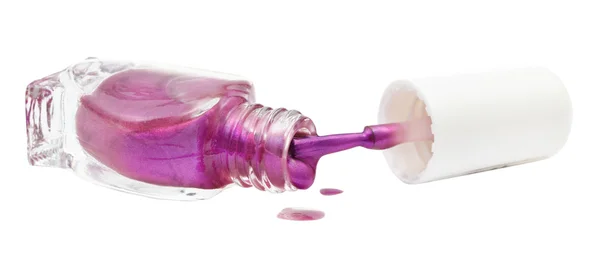 Bottle and spilled purple nail polish isolated — Stock Photo, Image