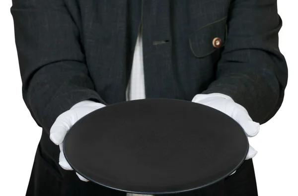 Above view of empty black plate in hands in gloves — Stock Photo, Image