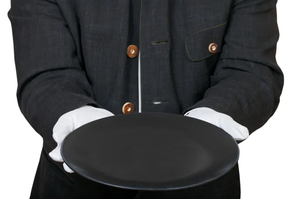 Front view of empty black plate in hands in gloves — Stock Photo, Image