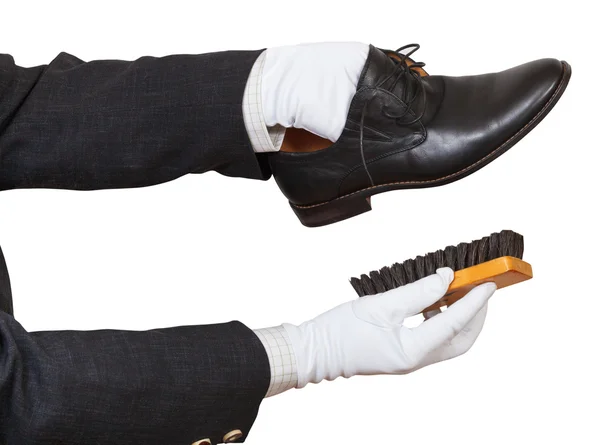 Shoeshiner in white gloves cleaning black shoes — Stock Photo, Image