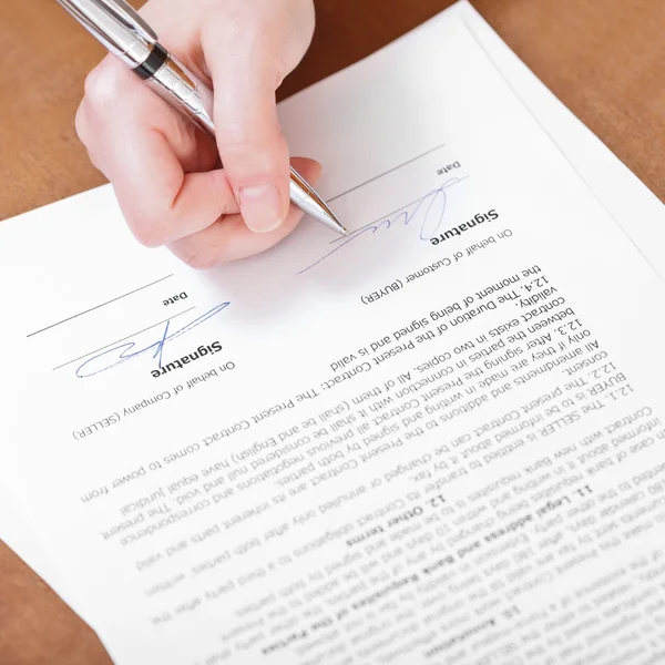 Cliente firma un accordo con penna argento — Foto Stock