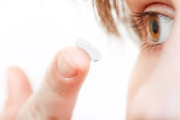 Girl inserts contact lens in eye — Stock Photo, Image