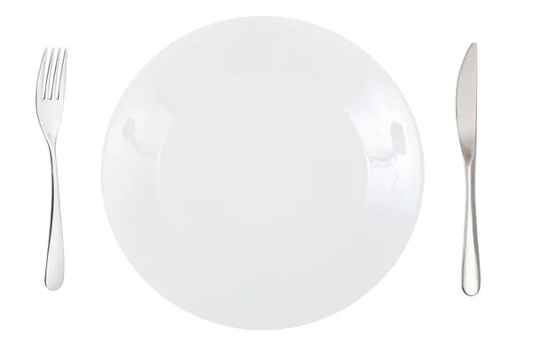 Top view of porcelain dinner plate with cutlery — Stock Photo, Image