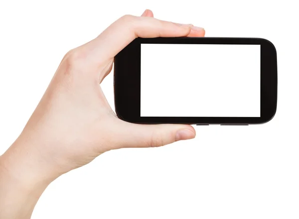 Mano sosteniendo teléfono inteligente aislado en blanco — Foto de Stock