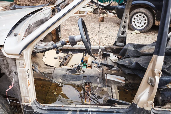 Disassembled car at an automobile dump — Stock Photo, Image