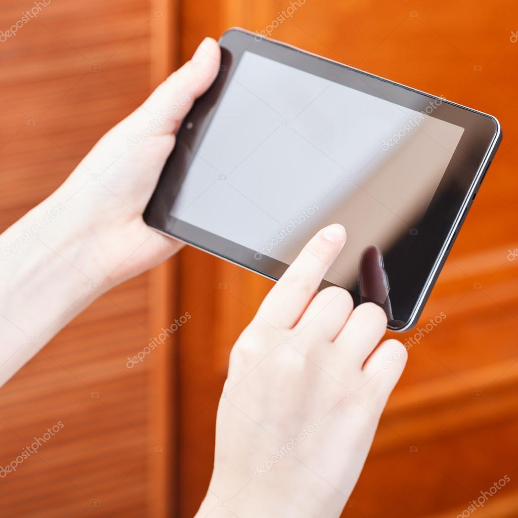 finger pressing tablet pc in office