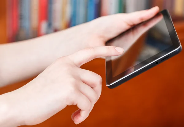 Finger clicking touchpad screen in library — Stock Photo, Image