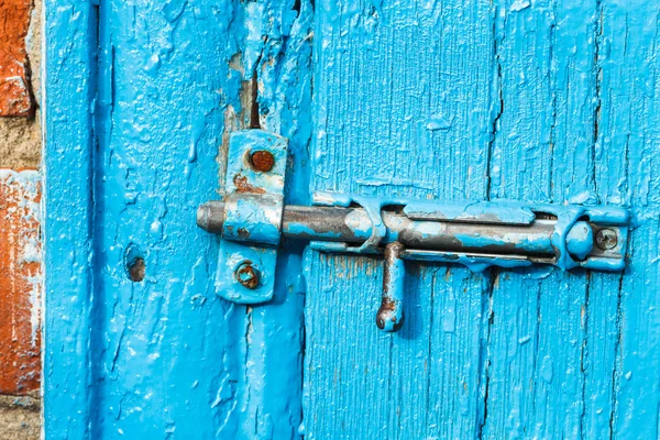 Shabby espagnolette on old blue painted door — Stock Photo, Image
