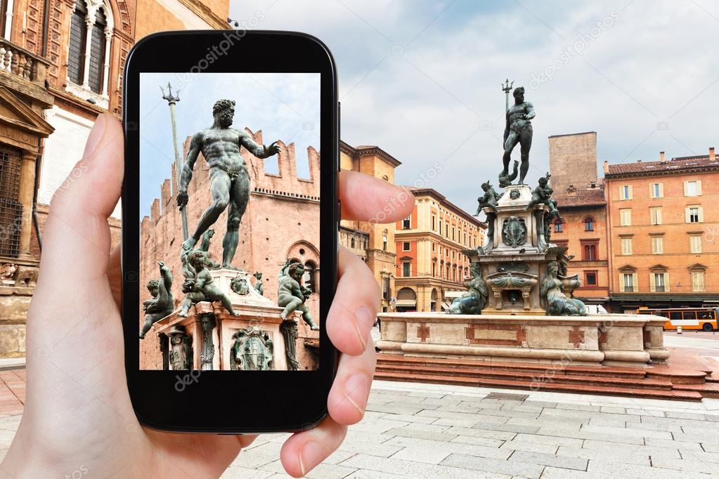 tourist taking photo of Piazza Nettuno in Bologna
