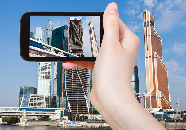 tourist taking photo of new Moscow City buildings
