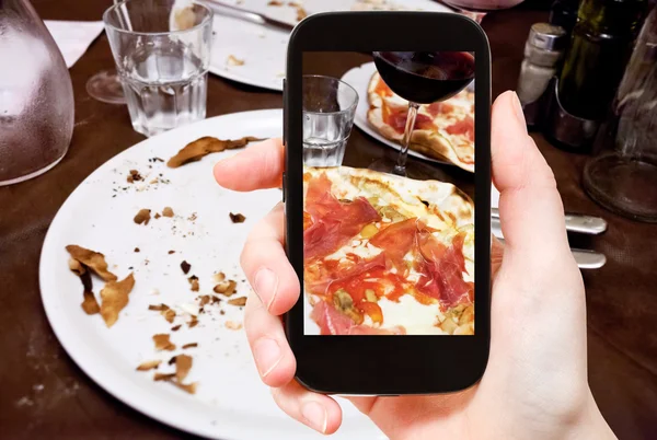 Turist fotograferar italiensk pizza med parmaskinka — Stockfoto