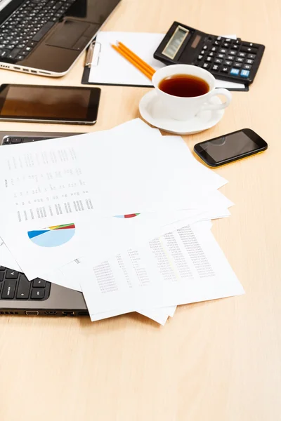 Paper charts and modern office tools on table — Stock Photo, Image