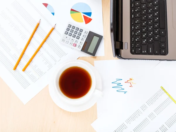 Cup of tea on table with tools in modern office — Stock Photo, Image