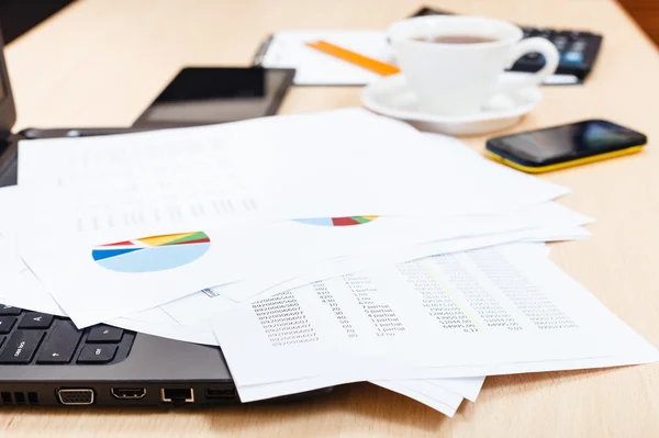 Charts and modern office tools on desk — Stock Photo, Image