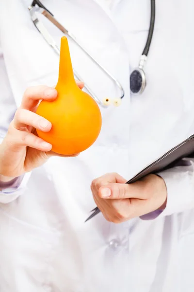 Doctor hold yellow rubber enema — Stock Photo, Image