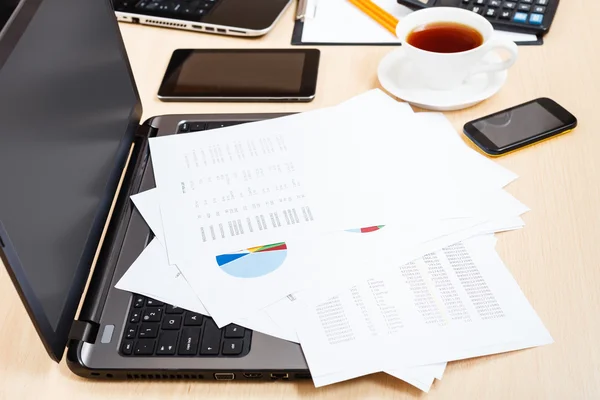 Paper charts and modern office tools on desk — Stock Photo, Image