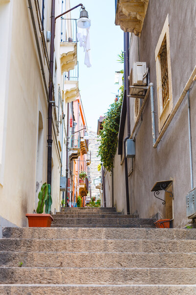 Narrow street via Ciraulo in Catania city, Sicily, Italy