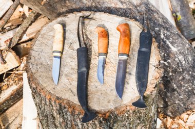 hunting knives on wooden stump clipart