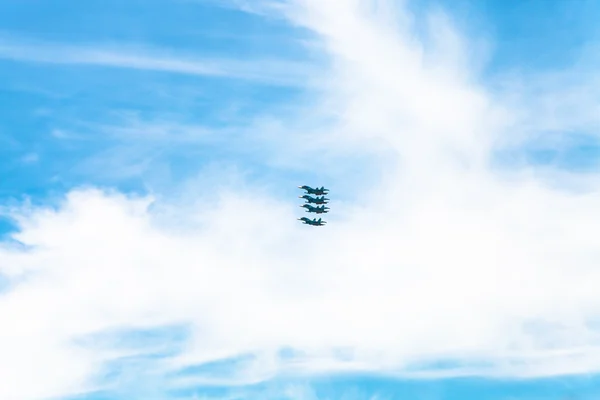 Four military fighter aircrafts in white clouds — Stock Photo, Image