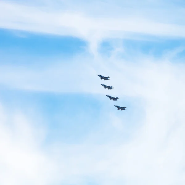 Four military fighter jets in cloudy sky — Stock Photo, Image