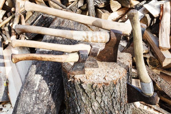 many various axes in wooden block