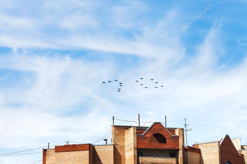 fighters and attack aircrafts in sky over house