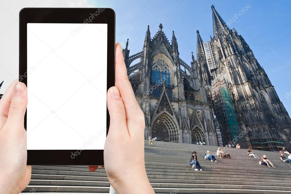 Travel concept - tourist photograph Cologne Cathedral, Gernany on tablet pc with cut out screen with blank place for advertising logo