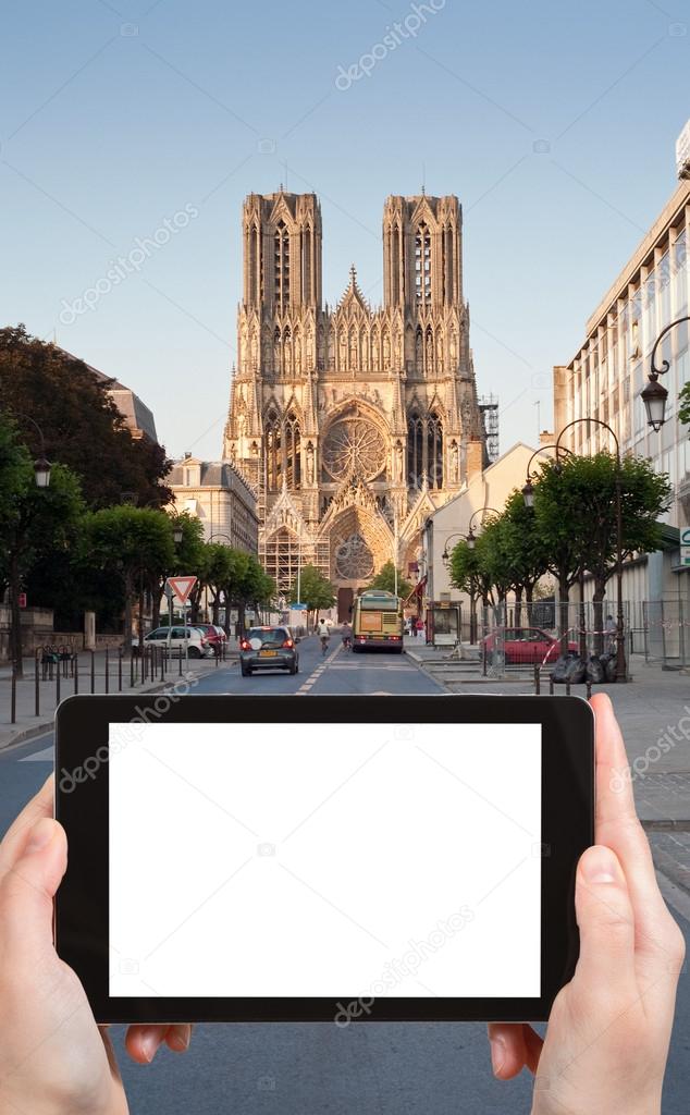Travel concept - tourist photograph gothic catholic Notre Dame Cathedral in Reims, Franceon tablet pc with cut out screen with blank place for advertising logo