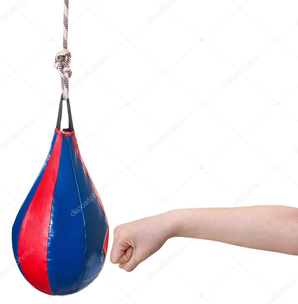 child punches punching bag isolated