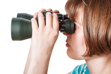 side view of girl looks through field glasses