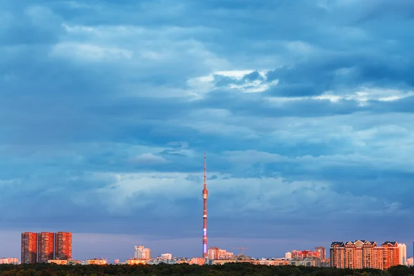 Голубые облака над освещенным городом на закате — стоковое фото
