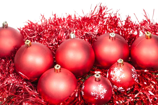 Several red Christmas baubles and tinsel isolated — Stock Photo, Image