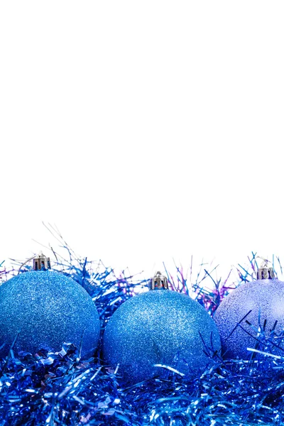 Three blue Xmas balls at tinsel close up isolated — Stock Photo, Image