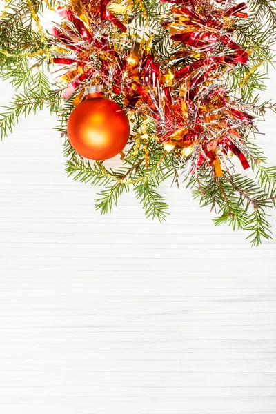 One gold Xmas ball and tree branch on blank paper — Stock Photo, Image