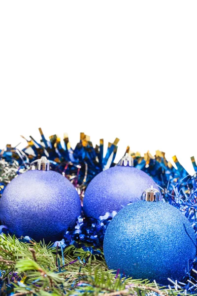 Blue and violet Xmas balls on green spruce branch — Stock Photo, Image
