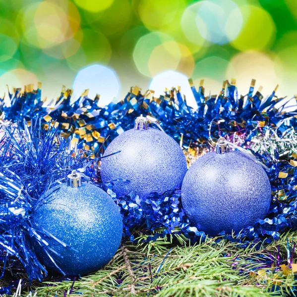 Xmas blue balls on blurred green background — Stok fotoğraf