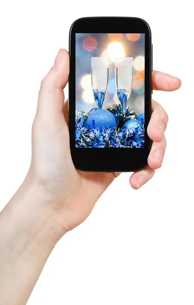 Hand holds cellular phone with Xmas still life — Φωτογραφία Αρχείου