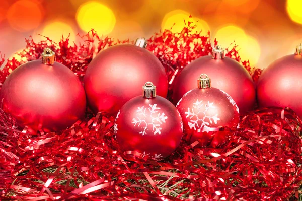 Xmas red baubles and tinsel on red background — Stock Photo, Image