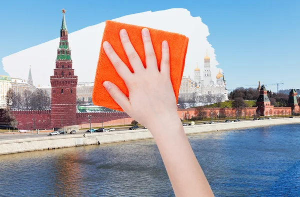 Hand deletes summer view of Moscow by orange cloth — Stock Photo, Image