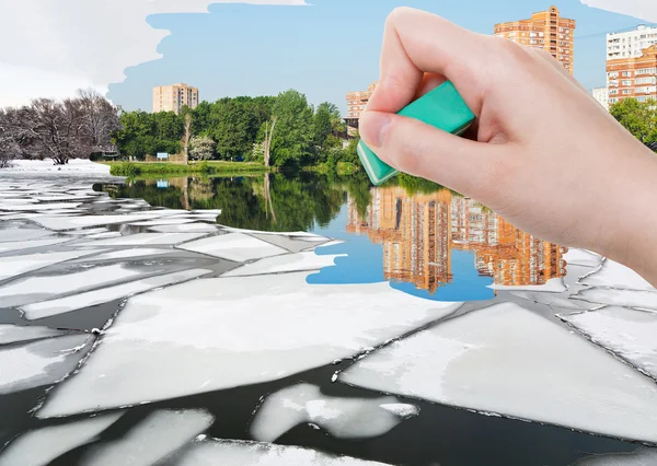 Hand deletes ice floe near waterfront by eraser — Stockfoto