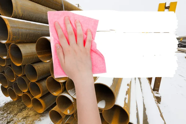 Hand deletes industrial landscape by pink rag — Stock Photo, Image