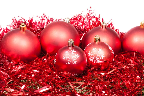 Many red Christmas balls and tinsel isolated — Stock Photo, Image