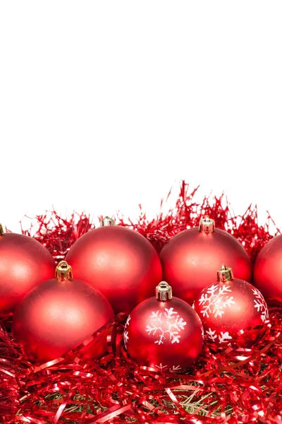 Several red Xtmas baubles and tinsel isolated — Zdjęcie stockowe